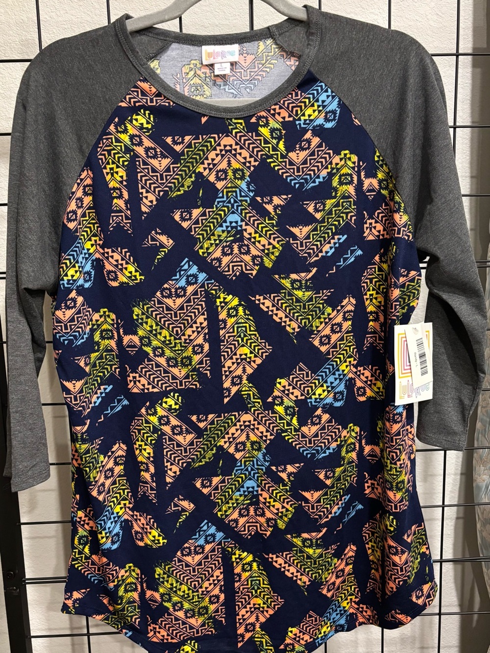 LuLaRoe Navy Geometric Print Raglan with Gray Sleeves and Neon Accents